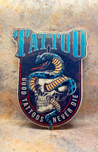 Load image into Gallery viewer, Bold Tattoo-Inspired Metal Wall Sign - Classic Skull and Serpent Art, Durable Metal Tattoo Studio Decor, Edgy Wall Art-OsirisTradingUK
