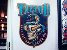Load image into Gallery viewer, Bold Tattoo-Inspired Metal Wall Sign - Classic Skull and Serpent Art, Durable Metal Tattoo Studio Decor, Edgy Wall Art-OsirisTradingUK
