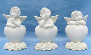 Set of Three Guardian Angel Figurine Cherubs Resting on Heart Ornament Sculpture
